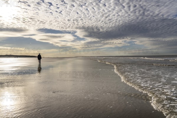 Walkers on the Wadden Sea near the East Frisian island of Spiekeroog, west of the North Sea island,