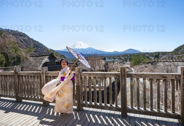 Japanese woman in kimono with umbrella, Iyashinosato open-air museum, old Japanese village with