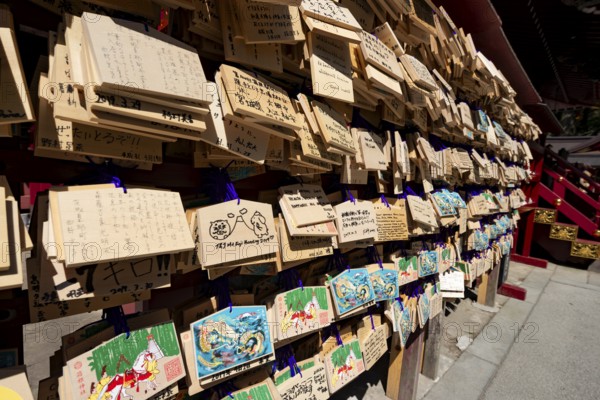 Ema, small wooden tablets with wishes and prayers, hung so that the Kami spirits or gods can