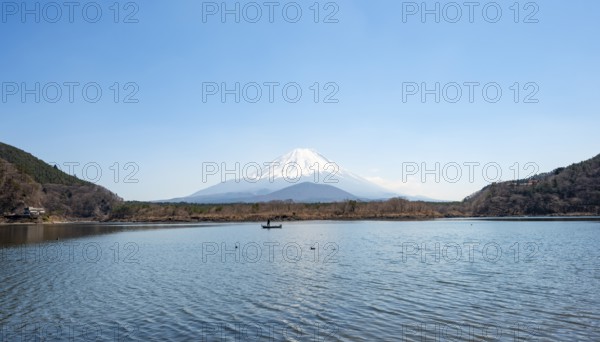View across the lake to Mt Fuji volcano, Motosu Lake, Yamanashi Prefecture, Japan
