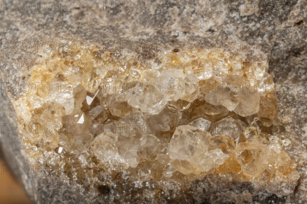 Translucent crystals shimmer in granite rocks. The discovery takes place in summer in a quiet,