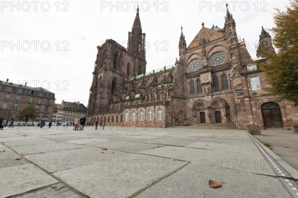 Strasbourg Cathedral impresses with its Gothic architecture. Passers-by moves around the square