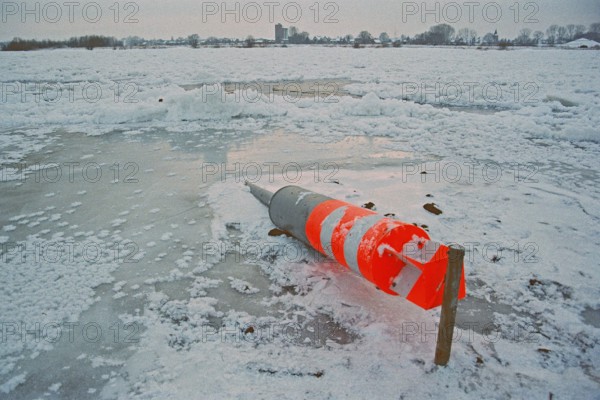 Buoy lying on ice rink, frozen Elbe, Bleckede, Lower Saxony, Germany, January 03, 1997, vintage,