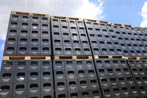 Stacked black beer crates from the Kulmbacher Group, a beverage manufacturer that includes