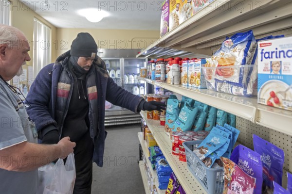 Detroit, Michigan USA - 4 November 2025 - People pick up groceries at the nonprofit Deo Gratias