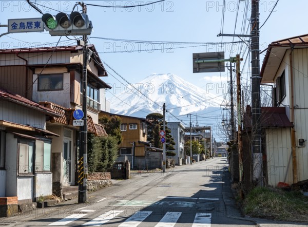 Street scene in a residential area, residential buildings and power lines, view of Mt. Fuji,