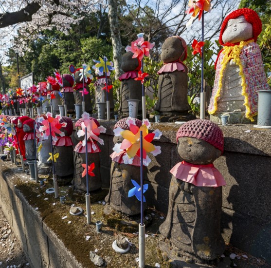 Jizo statues with red crocheted caps, guardian deities for deceased children, Unborn Children