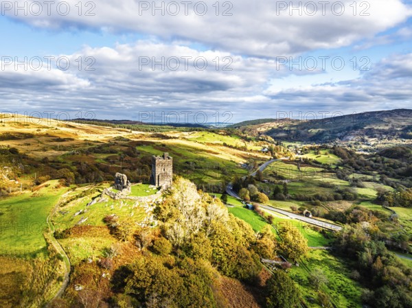 Autumn colours over Castell Dolwyddelan and Eryri Mountains from a drone, Snowdonia, Conwy County