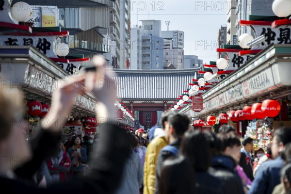 View of numerous visitors on Nakamise-dori shopping street at the Thunder Gate Kaminarimon of