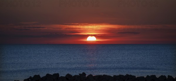 Sunset on the Baltic Sea with protective breakwaters, Darß, Ahrenshoop, Mecklenburg-Western