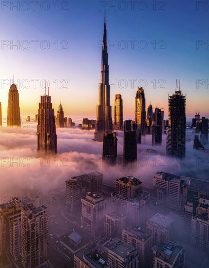 City scape emerging from a dense enveloping fog in sunrise and skyscrapers piercing the haze, big