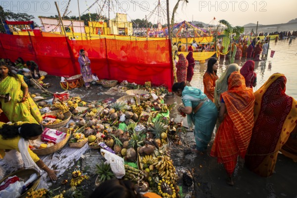 Hindu devotees gather on the banks of the Brahmaputra River to offer prayers to the Sun God on the