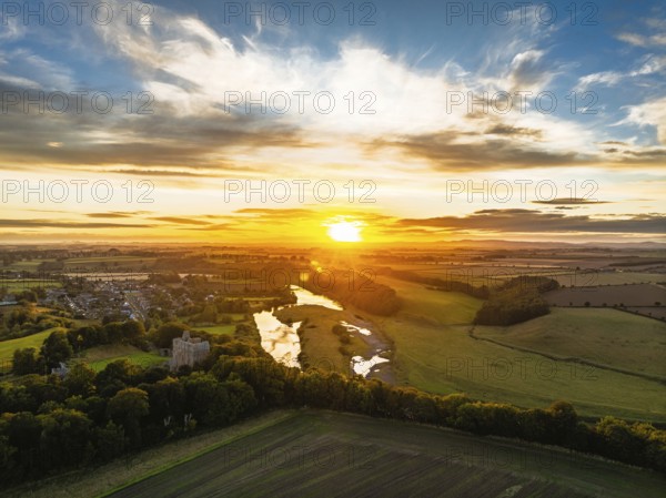 Sunset over Norham Castle and River Tweed from a drone, Norham, Northumberland, England, United
