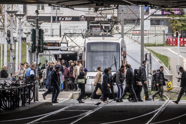 Pedestrians cross the tram tracks, at Düsseldorf-Bilk station, junction of S-Bahn, subway, tram,
