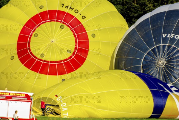 Hot air balloons being prepared for take-off as part of an air show at the Rossfeld in