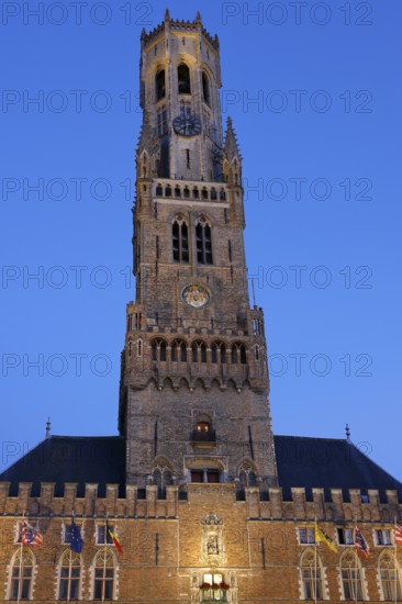 Illuminated Belfry in the historic city centre of Bruges in the evening light, Belfort and City