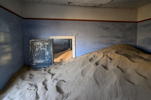 Sand mountains in a former dwelling house, interior photograph, Kolmanskop, restricted diamond