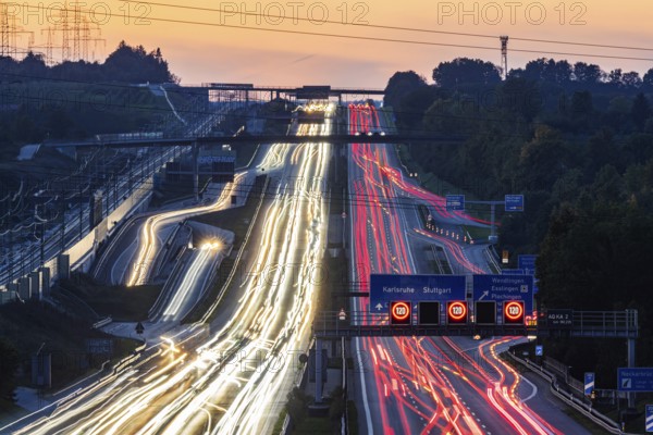 Motorway near Stuttgart with several lanes in the evening with sunset. Heavy traffic with light