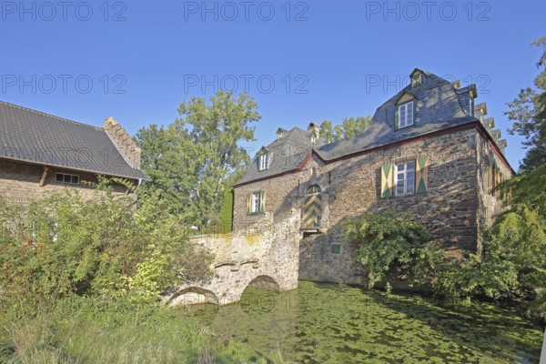 Manor house with stone arch bridge in the inner courtyard of the Kleeburg castle built in the 14th
