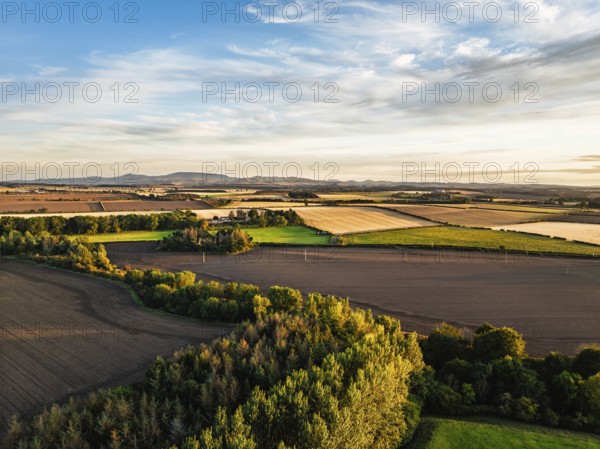 Sunset of Farms and Fields over Norham Castle from a drone, Norham, River Tweed, Northumberland,