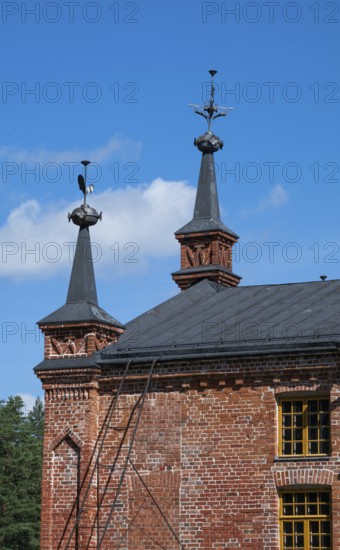 Gable with weather vane and ornamental iron elements, former paper factory and mill for the