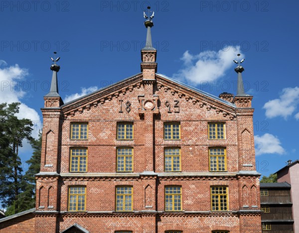 Multi-storey brick façade with inscription 1893, former paper factory and mill for the production