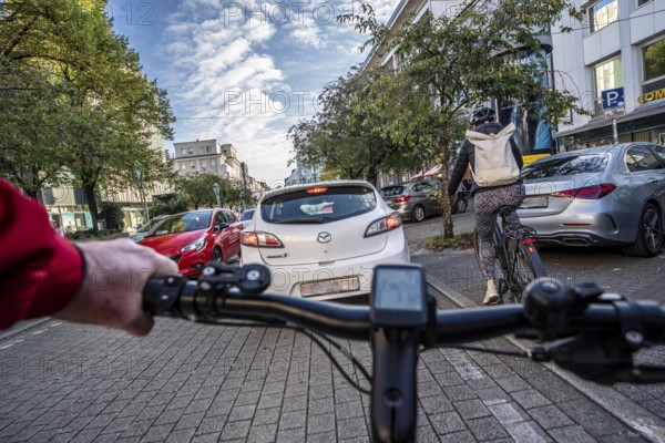 Cycling in the city, city centre road, cycle lane, two-wheeled traffic has priority, 30 km/h zone,