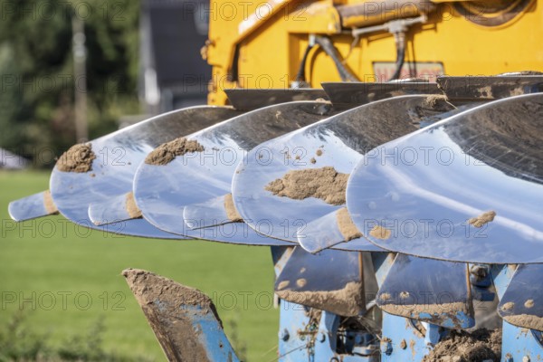 Plough, for ploughing a field, field, ploughshares, agricultural technology, shiny stainless steel,