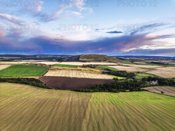 Sunset of Fields and Farms over Traprain Law and Hailes Castle from a drone, River Tyne,