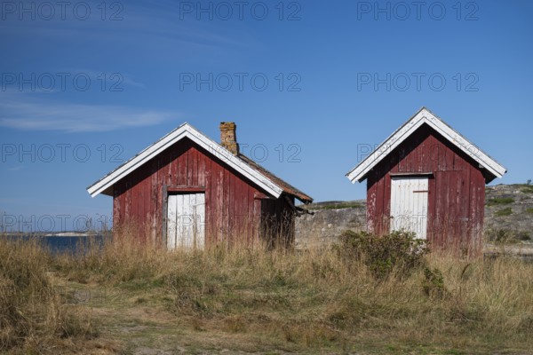 Falun red or Swedish red boathouses by the sea, Resö Island, Bohuslän, Skagerrak, Sotenäs, Västra