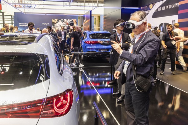 Mercedes trade fair stand with virtual presentation. Trade fair visitors with 3D glasses. The