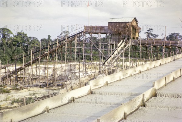Open Cast gravel-pumping tin mine Malaya, Malaysia, south east Asia 1964 - Ore separation in the