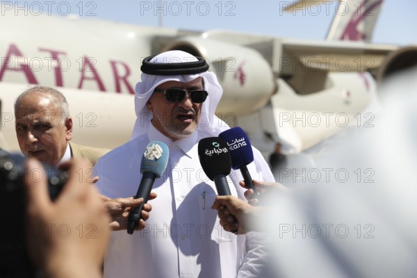 Officials from the Qatari and Syrian Red Crescents receive a Qatari airlift of aid to help the