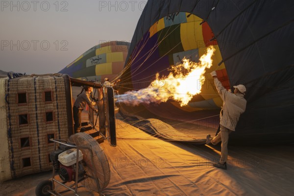 In order to get ready for the take-off, the pilot inflates the balloon with hot air by activating