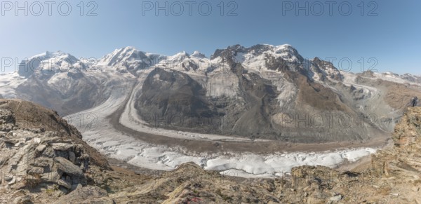 At dawn, the sun bathes the peaks of the Alps in a golden light and reveals stunning glaciers and