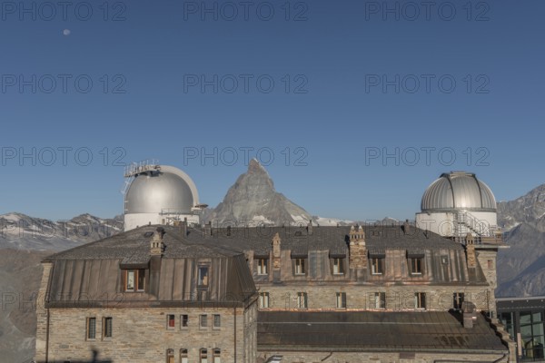 This breathtaking view shows the iconic Matterhorn mountain rising behind a historic observatory
