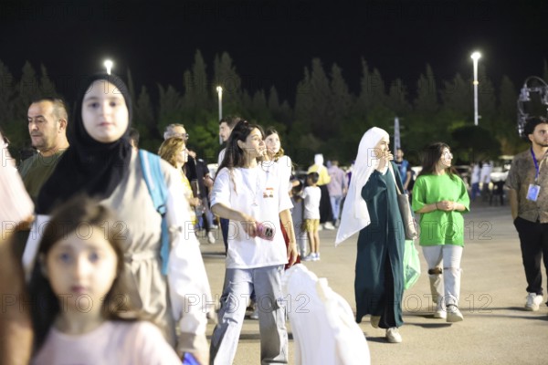 Audience members enjoy a musical performance during the Damascus International Fair in Damascus,