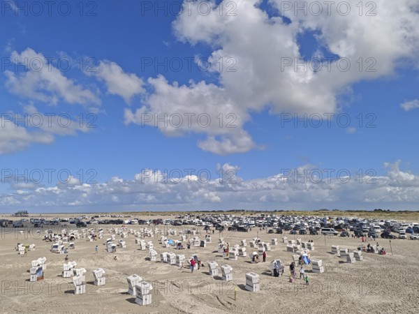 North Sea beach, car park, blue sky, white clouds, summer, sun, sand, beach chairs, on the edge of