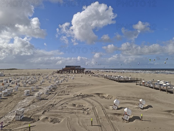 North Sea beach with sand drifts, car park, blue sky, white clouds, summer, sun, beach chairs, on