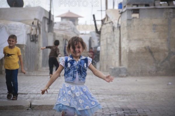 Syrian children playing in a refugee camp near the Turkish border on World Children's Day. Aleppo,
