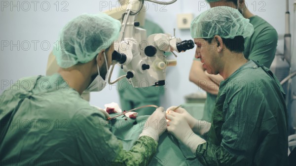 Several doctors performing a complex surgical operation inside an operating room for a displaced