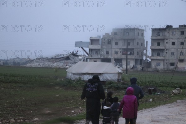 Civil defense teams attempt to rescue civilians trapped under the rubble after a powerful