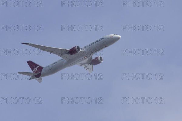 Boeing 787 Dreamliner jet passenger aircraft of Virgin Atlantic airlines in flight in a blue sky,