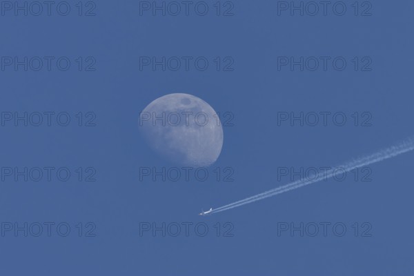 Boeing 737 jet passenger aircraft of Norweign Air with a vapour trial or contrail behind flying in