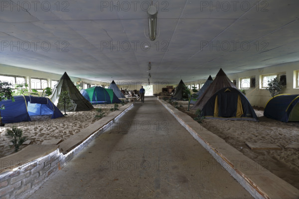 Indoor campsite in a former cattle shed at Fleether Mühle, Müritz National Park,