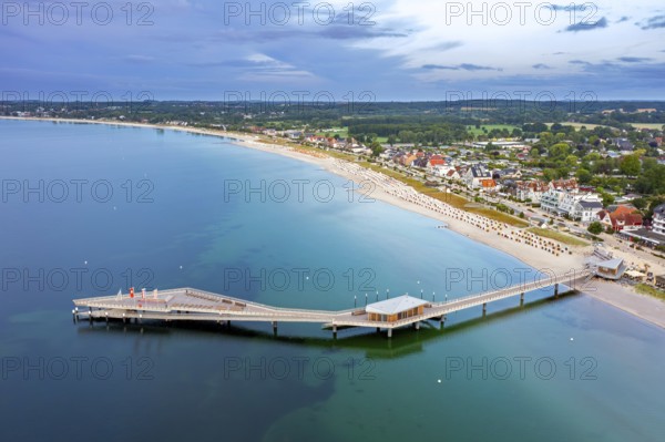 Aerial view over Seebrücke, pier and sandy beach at seaside resort Haffkrug along the Baltic Sea,