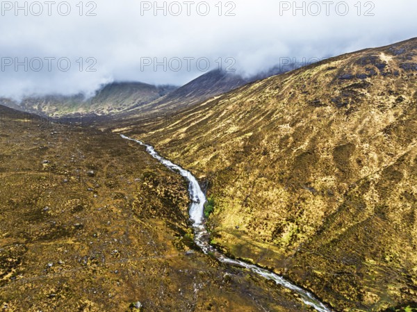 Eas a' Bhradain Waterfall from drone, Red Cuillin mountains, Loch Ainort, Isle of Skye, Scotland,