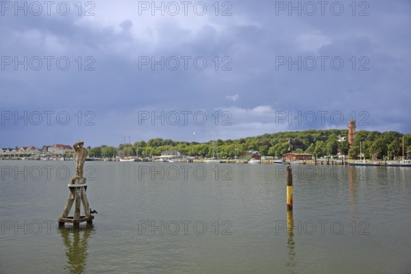 Trave with monument to sailor Fiete, wood carving, Dückdalbe, dolphin, old lighthouse, shore,