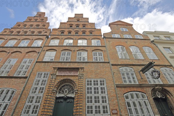 Historic Schabbelhaus built in the 18th century with stepped gable, brick building, nose sign,