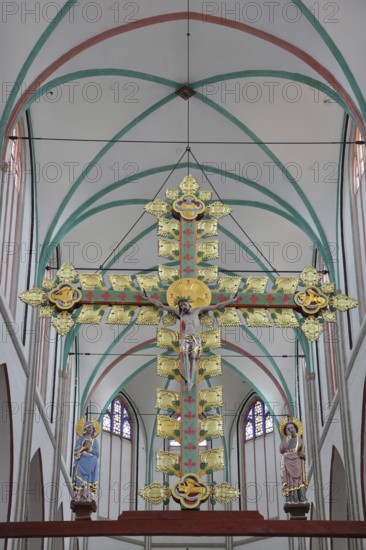Gothic golden triumphal cross from 1420 with church patron Saint John the Apostle and Mary in the